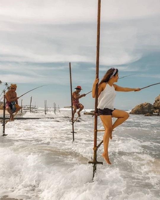 stilt fishing by a girl in koggala